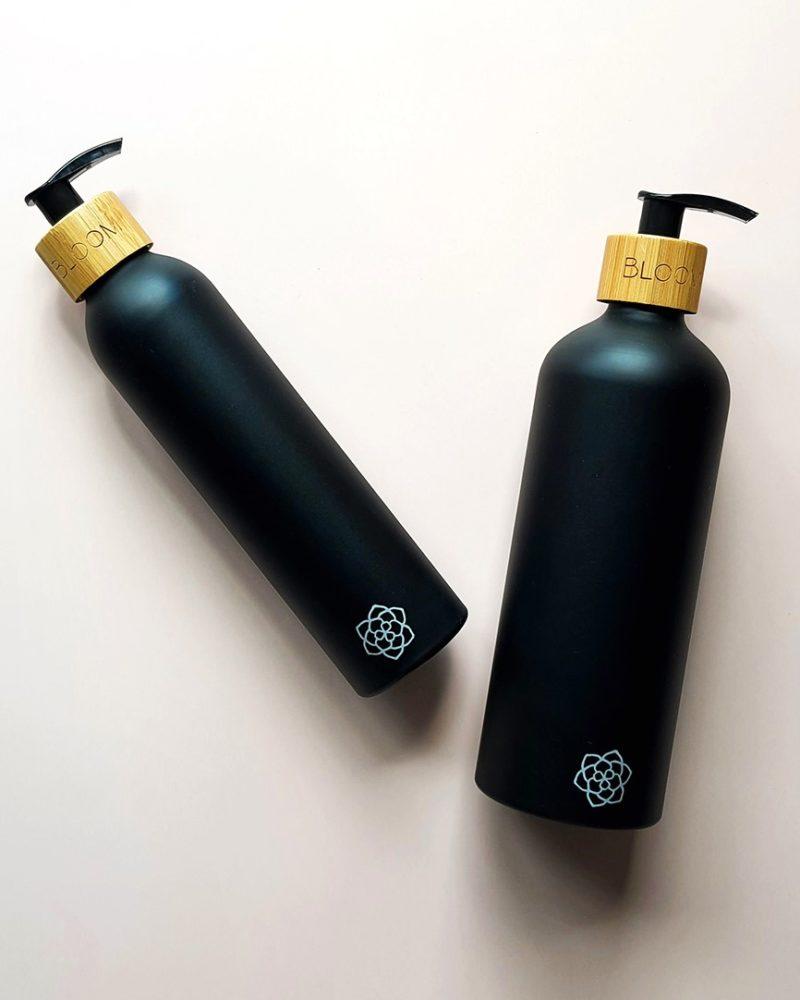 Black refillable soap dispenser set with bamboo pump.