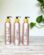 Personalized shower bottle dispenser set with bamboo pump.