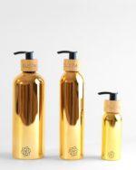 Refillable ecofriendly bathroom bottle set in shiny gold with bamboo pump