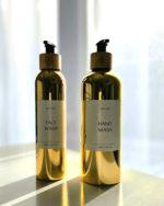 Refillable ecofriendly shower bottle set in shiny gold with bamboo pump