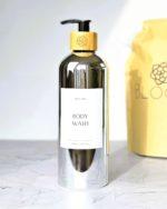 Refillable ecofriendly shower gel bottle in shiny silver with bamboo pump