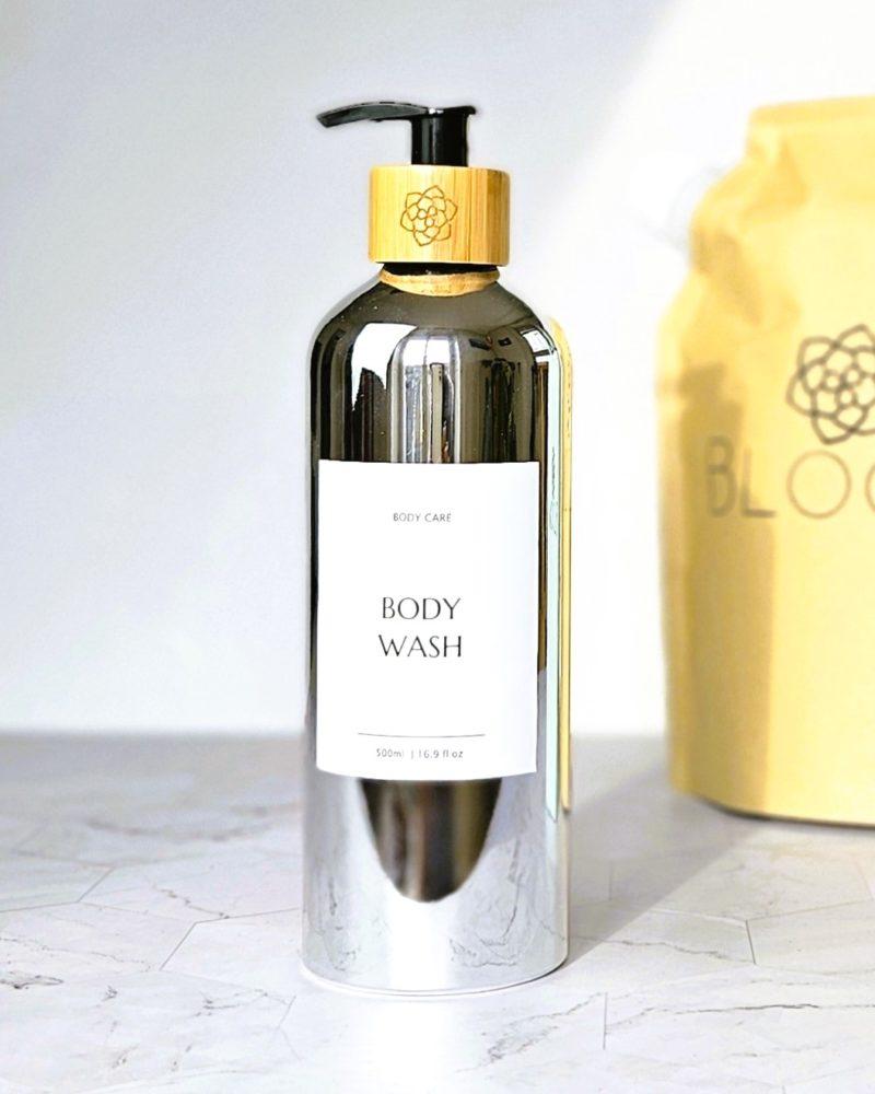 Refillable ecofriendly shower gel bottle in shiny silver with bamboo pump