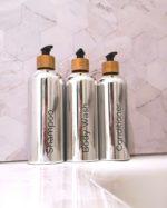 Refillable ecofriendly shower bottle set in shiny silver with bamboo pump