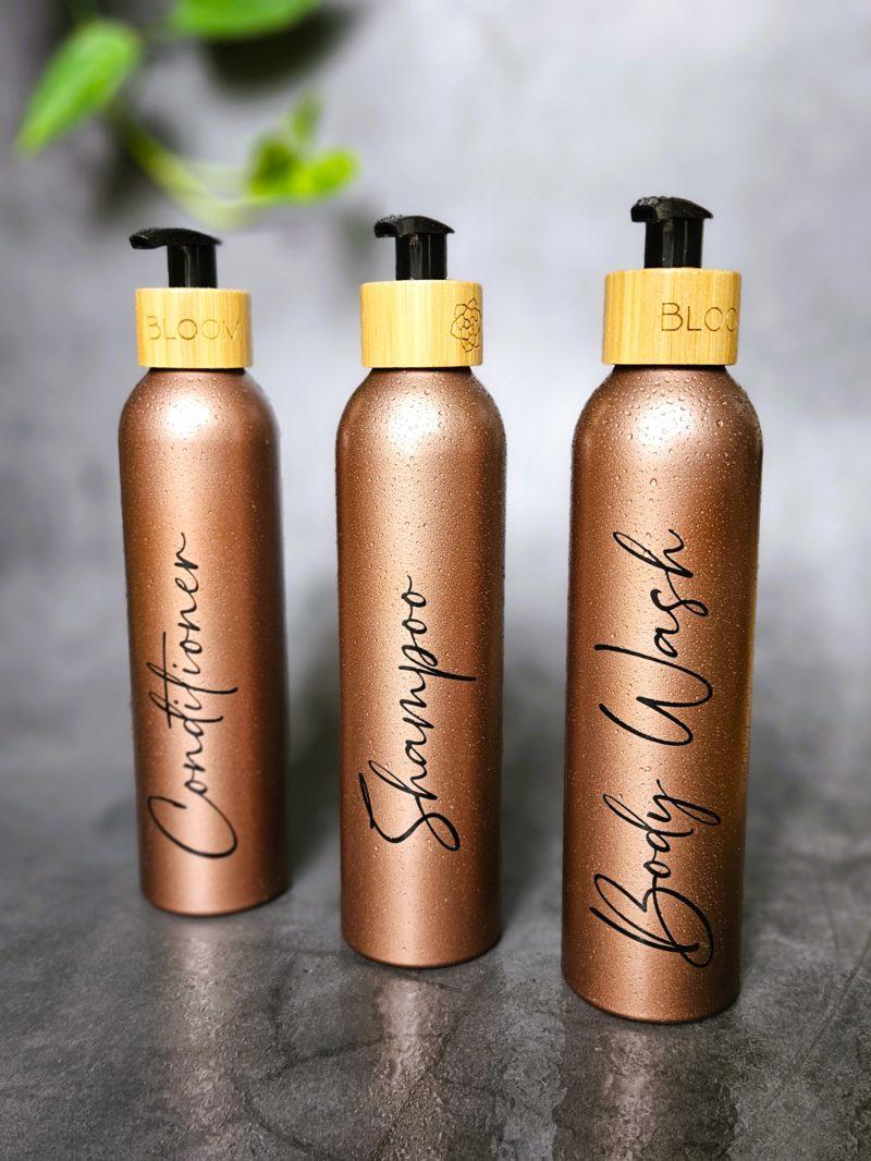 Reusable bathroom bottles for shampoo, conditioner and shoer gel. For an eco-friendly shower.