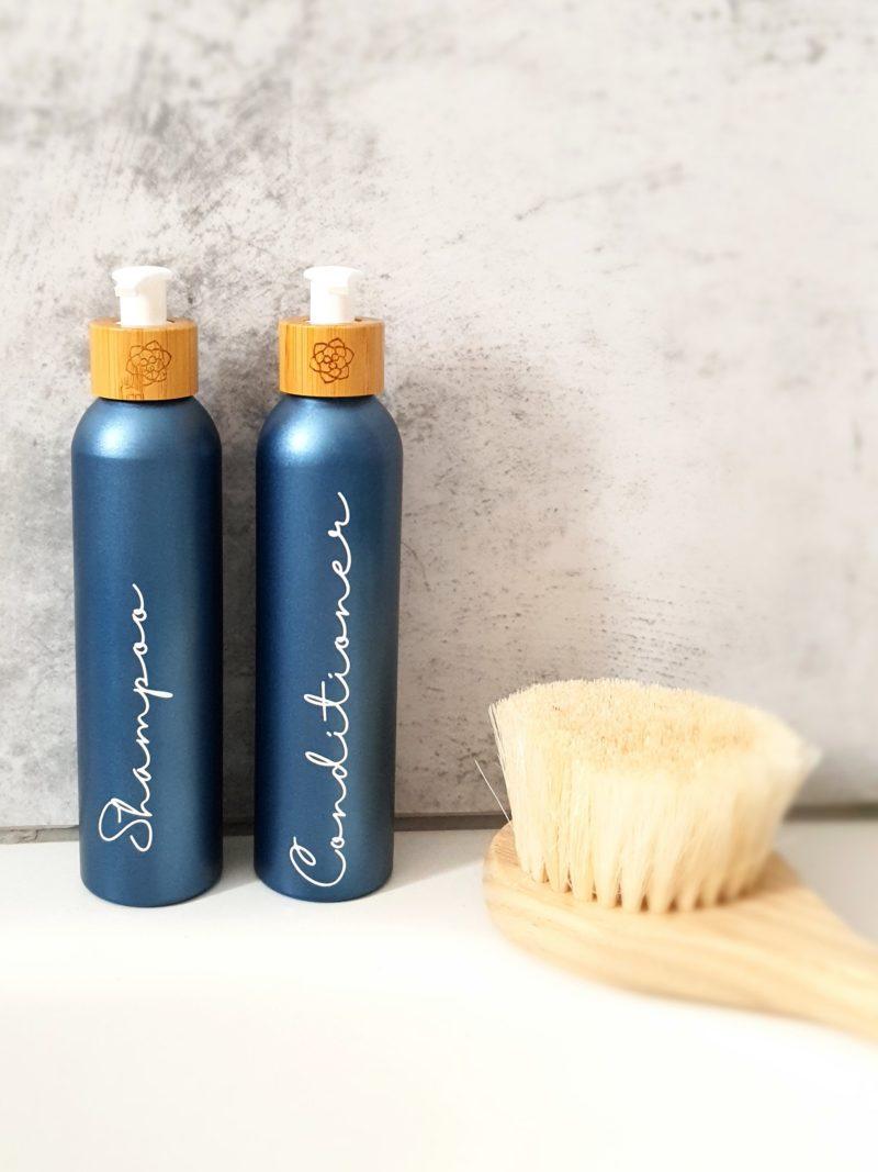 Refillable soap bottles for your shower, in metallic blue that adds style to your eco-friendly bathroom decor.