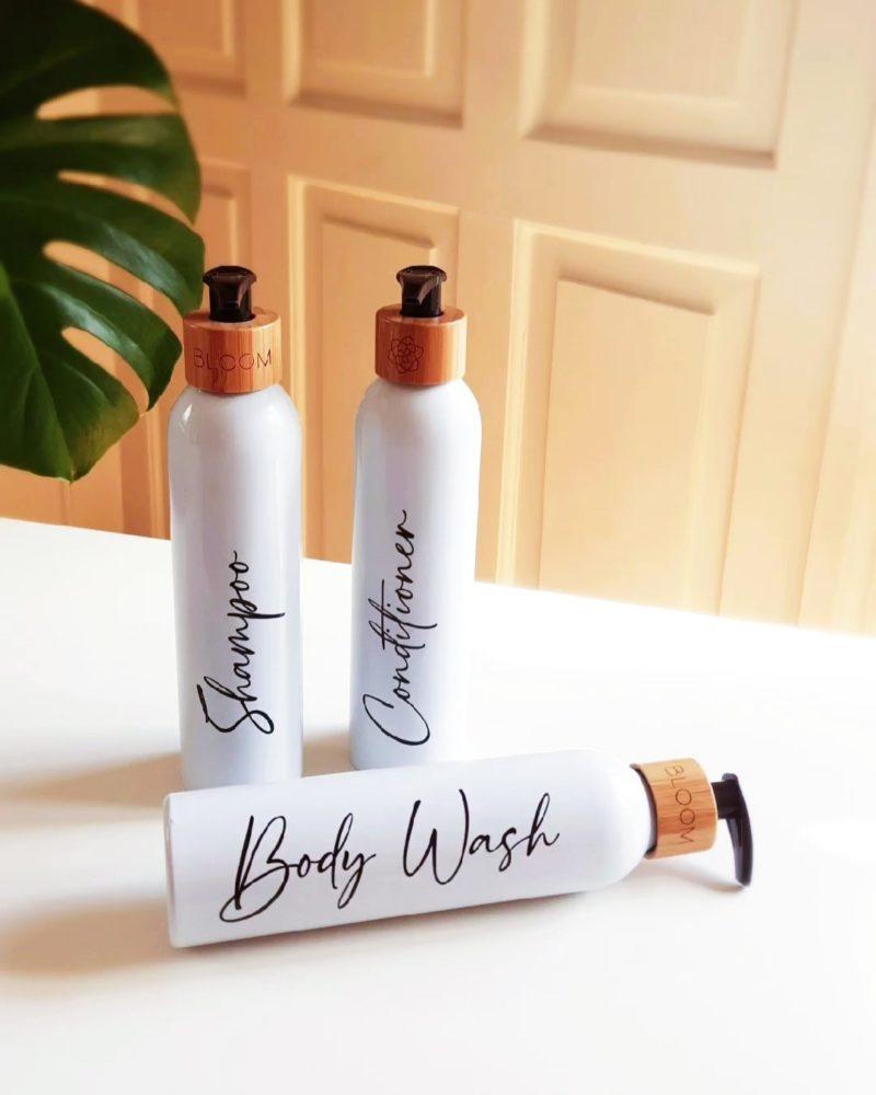 Personalized bathroom bottle set in white with bamboo pump for minimalist bathroom.