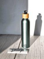 Effortless application of vinyl decal sticker to a bottle for a personalized bathroom decor.